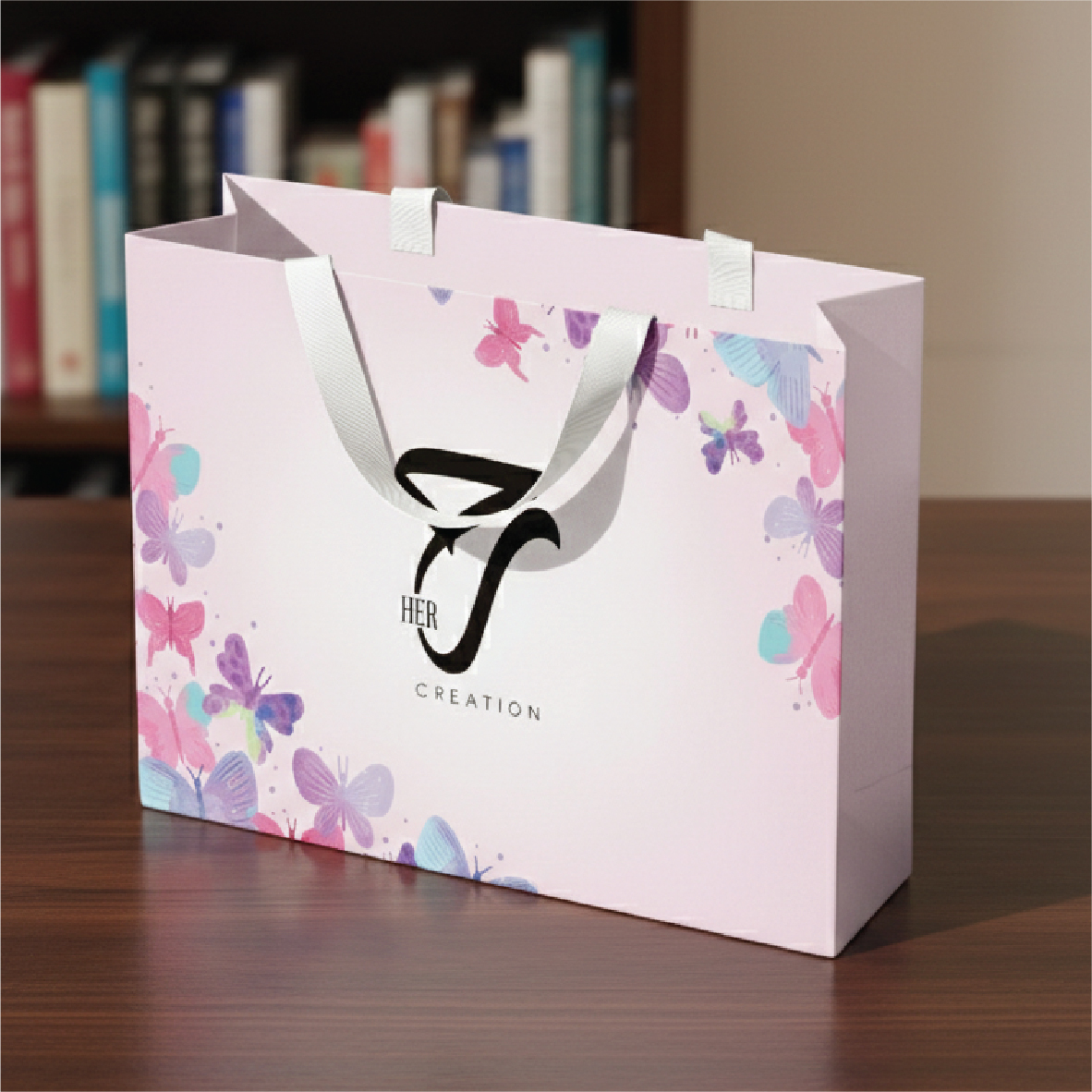 Printed ribbon handle paper bag with butterfly design and white satin handles for retail gift packaging
