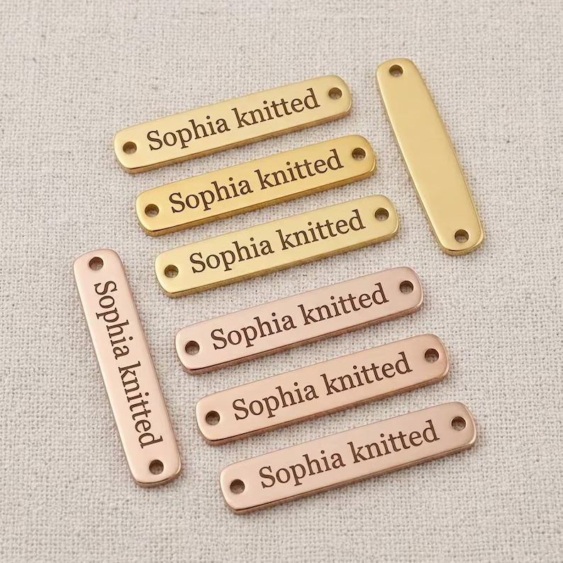 Rectangular custom metal tags for clothing, bags, and handmade products.